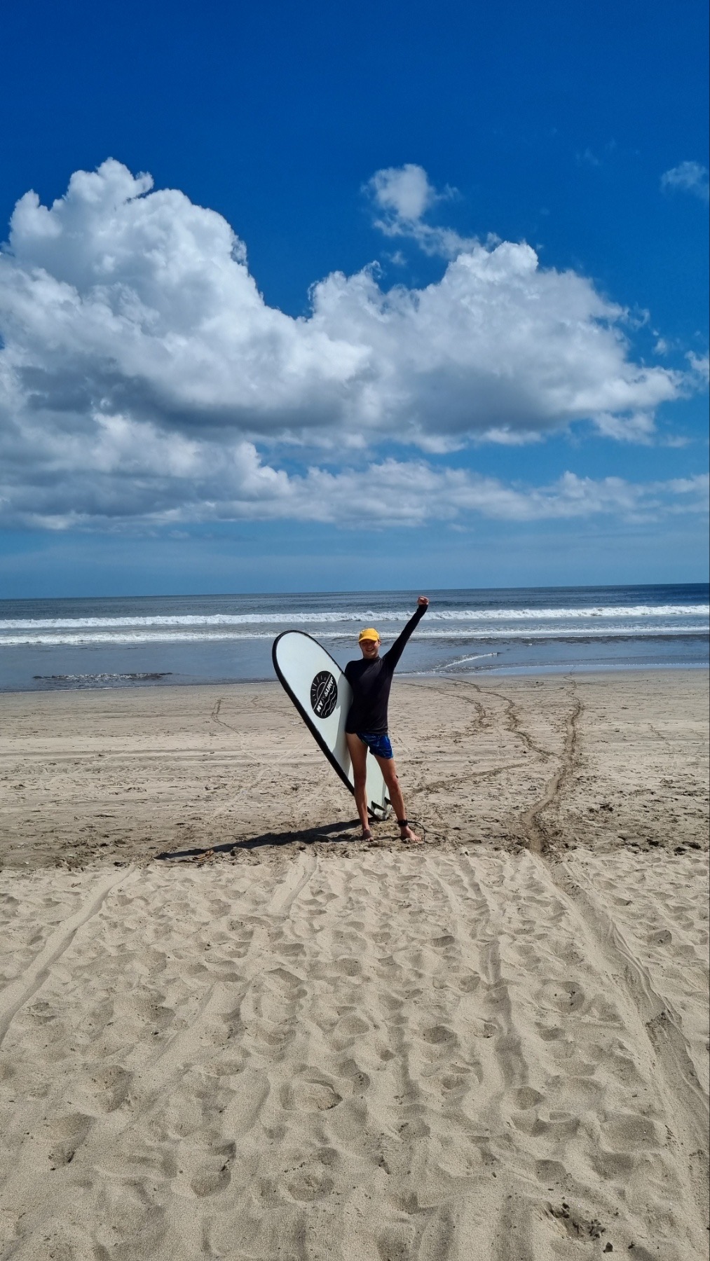 A beginner surfer riding a wave in Bali