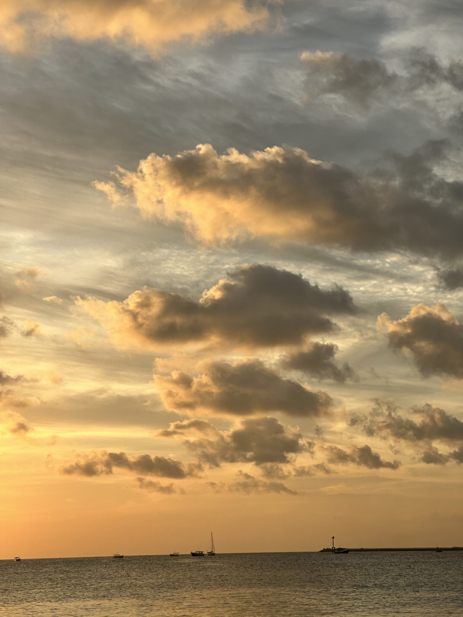 A breathtaking Bali sunset casting golden hues over the ocean
