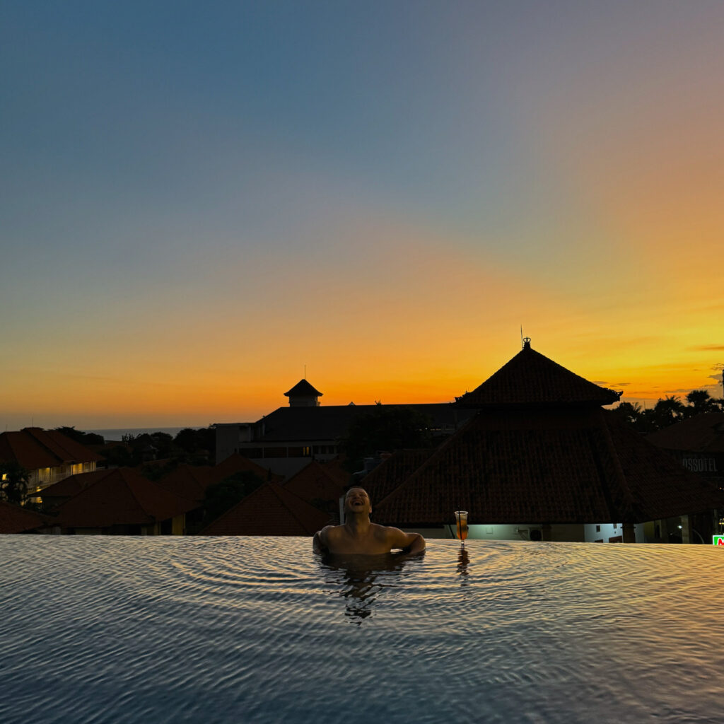 A traveler gazing at a stunning Balinese sunset, ready for the next adventure