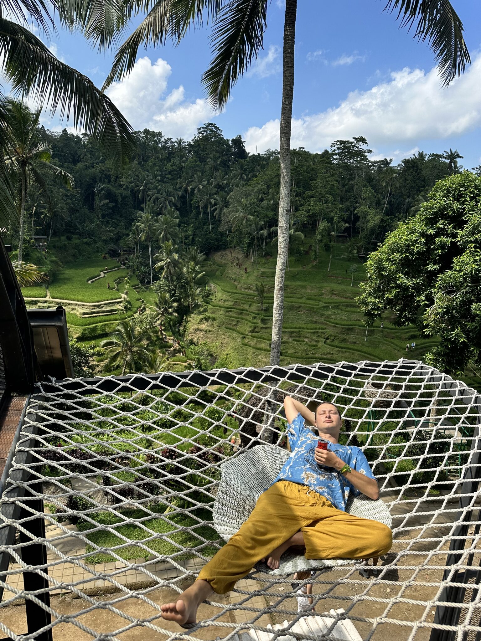 A traveler enjoying a hammock above Tegallalang rice fields, because they forgot to have a massage