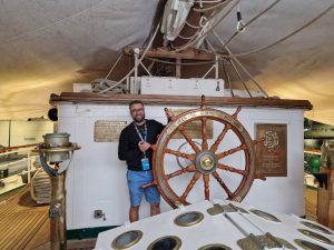 Milos, a digital nomad, learning how to maneuver a boat